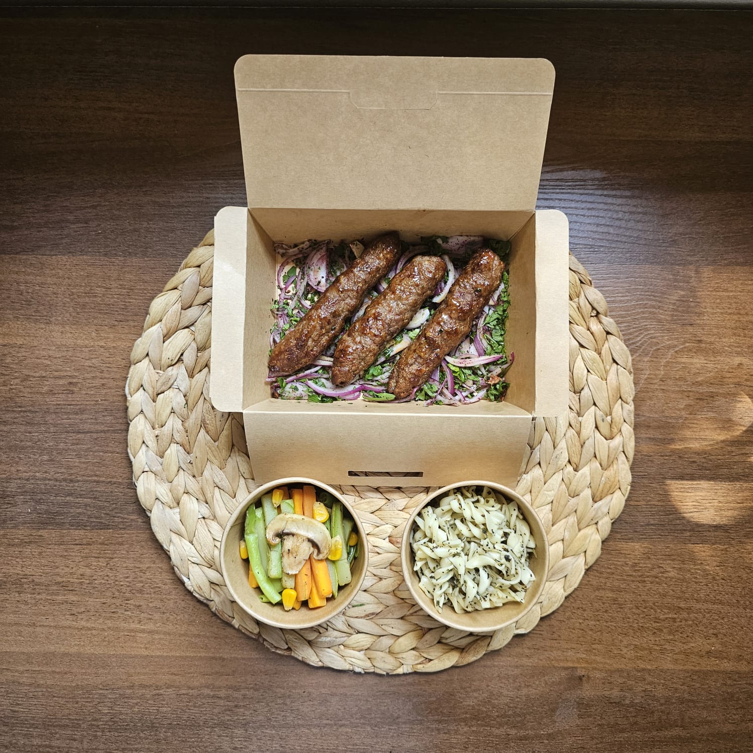 Grilled meat kofta served with  herb pasta and sautéed vegetables