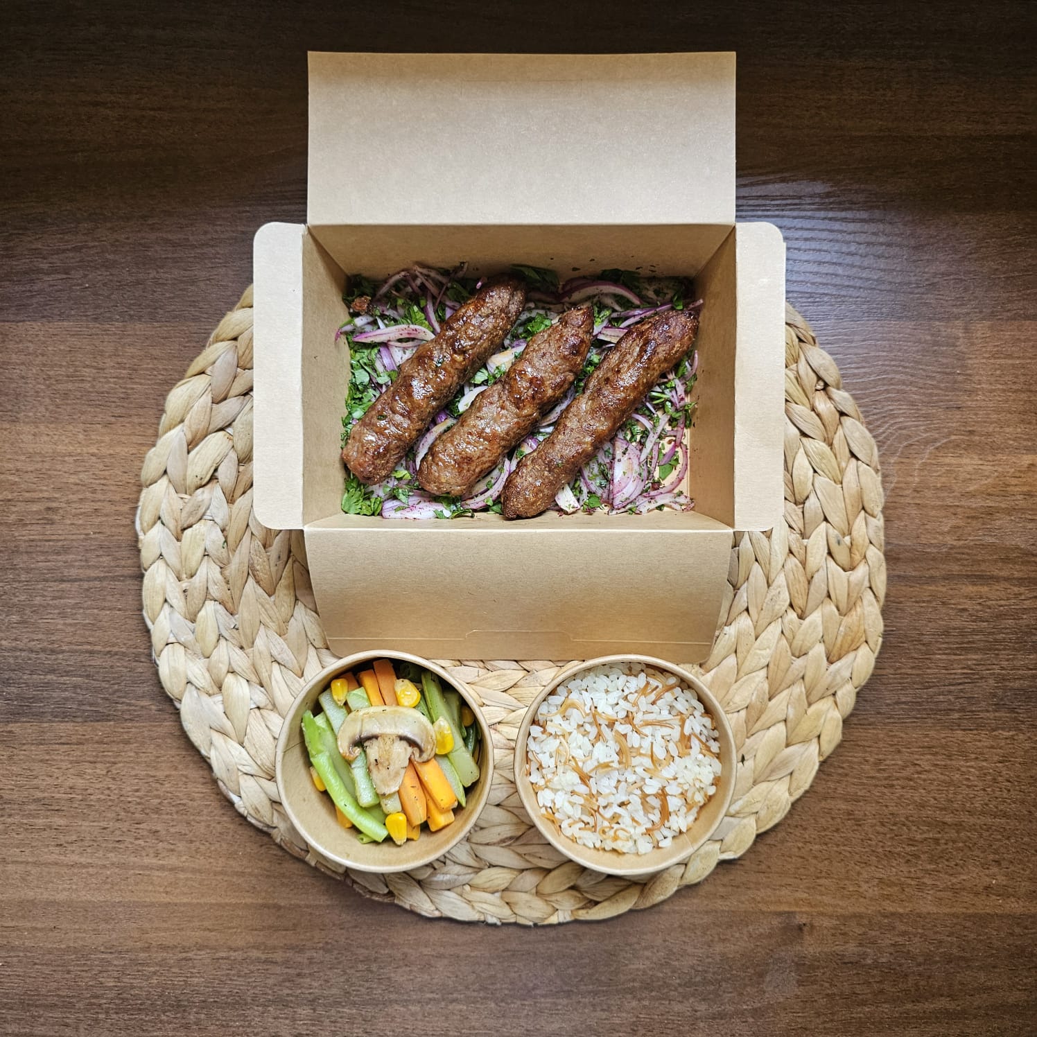 Grilled meat kofta served with vermicelli rice and sautéed vegetables