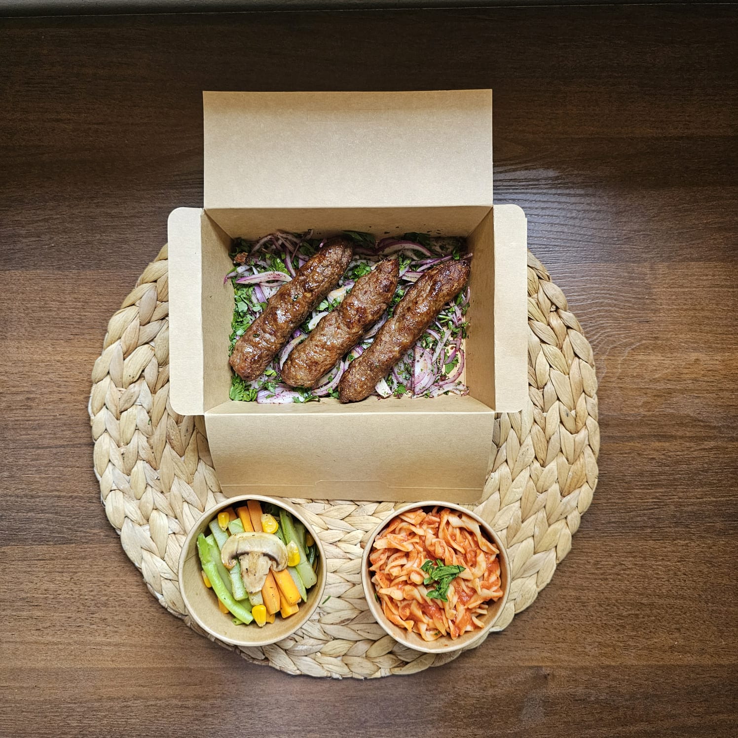 Grilled meat kofta with red sauce pasta and sautéed vegetables